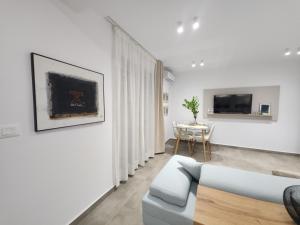 a living room with a couch and a table at Feel like home 2 in Shkodër