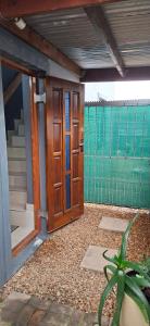 a wooden door of a house with a plant at Murray Guest Suite in Goodwood