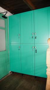 a group of green lockers in a room at Trigona Guest House & Hostel in Gjirokastër