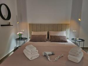 a bedroom with a large bed with towels on it at Feel like home 2 in Shkodër