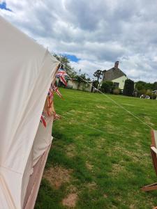 ein weißes Zelt in einem Hof mit einem Drachen in der Unterkunft Bell Tent 2 in St Austell
