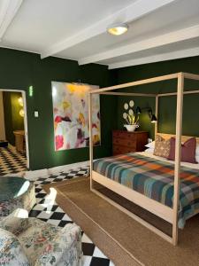 a bedroom with a canopy bed and green walls at The Hanover Luxury Hotel in Hanover +149 photos