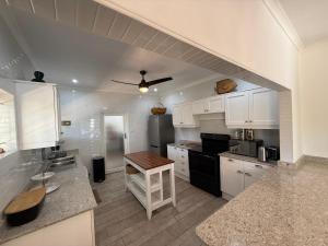 a kitchen with white cabinets and a counter top at Beachfront petfriendly cottage in Zinkwazi Beach