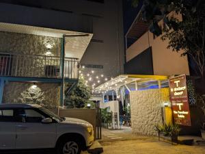 a car parked in front of a building at night at Hotel LG Signature Suites in Bangalore