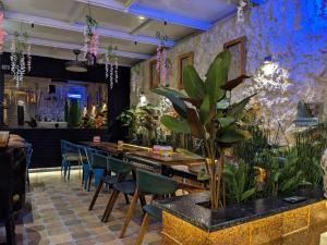 a restaurant with a table and chairs and plants at Hotel LG Signature Suites in Bangalore