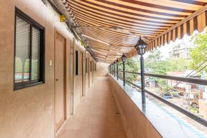 an empty corridor of a building with a wooden ceiling at Reay Road Residency Hotel in Mumbai