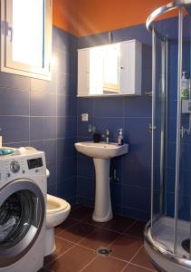 a bathroom with a washing machine and a sink at Old Port Manor in Mirina +34 photos
