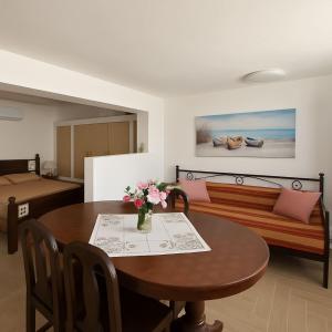 a living room with a table and a couch at Folegandros Galano Hideaway - Moniasma SeaViews in Ano Meria
