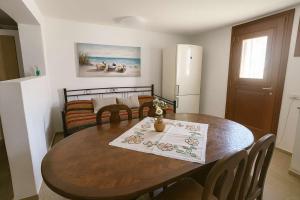 a kitchen and dining room with a wooden table at Folegandros Galano Hideaway - Moniasma SeaViews in Ano Meria
