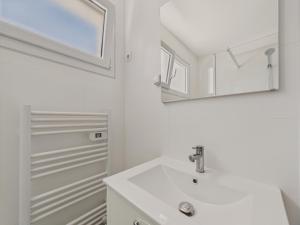 a white bathroom with a sink and a mirror at Une grande maison pour 10 proche de la mer in Saint-Gilles-Croix-de-Vie +53 photos