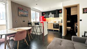 a kitchen and living room with a table and chairs at Duplex terrace - Paris & Marne in Saint-Maur-des-Fossés