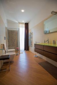 a bathroom with a tub and a sink and a toilet at Radici Resort in Mirabella Eclano