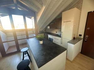 a kitchen with a black counter top in a room at Modern Apartment 5 mins Rho Fiera Milano in Rho