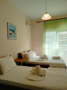 a room with two beds and a window at Eirini's Hause in Nea Moudania