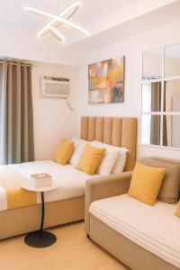 a bedroom with two beds and a couch at Studio 7 Residential Building in Manila