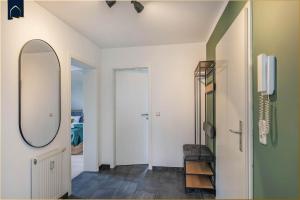 a hallway with a mirror and a dressing room at Dock23 in Kolpinsee +27 photos