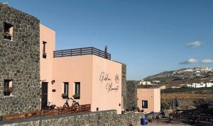 a building with writing on the side of it at Golden moments Luxury Stone Villas A in Mesaria