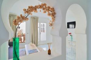 a living room with a table and a vase with flowers at Riad Salt Pool Bliss Apartamentos in Torremolinos