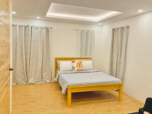 a bedroom with a bed and a window with curtains at Selah Nordic Guest house, with Wi-Fi, & Netflix in Palo +22 photos