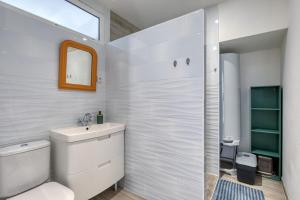 a bathroom with a toilet and a sink and a shower at Gîte A La Bonne Franck'ette in Aspiran +17 photos