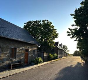 an empty street next to a brick building at Genuint hus i Höganäs hamn in Höganäs