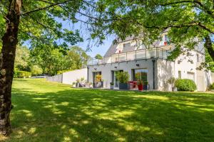 a house with a green lawn in front of it at Kerwall - Maison d'hôtes in Malville