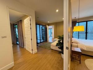 a bedroom with a bed and a room with a table at Monte Villa Chiang Mai in Ban Nong Chaeng +13 photos