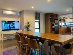 a large wooden table and chairs in a kitchen at Monte Villa Chiang Mai in Ban Nong Chaeng