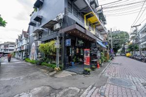 an empty street in an asian city with a building at KAYAN Hostel in Chiang Mai
