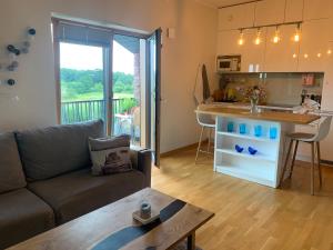 a living room with a couch and a kitchen at Merikotka apartment in Kuressaare