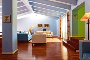 a living room with blue and green walls at Pousada Ria - Aveiro in Torreira +77 photos