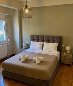 a bedroom with a large bed with two towels on it at Ηarmony 2 apartment next to the Acropolis museum in Athens