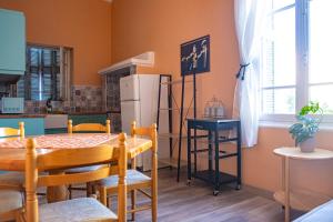 a kitchen with a table and a refrigerator at Old Port Manor in Mirina