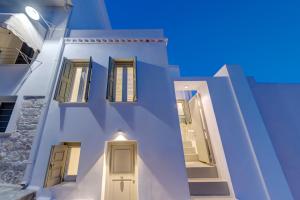 a view of a white building with a door at Aplotis home in Ermoupoli