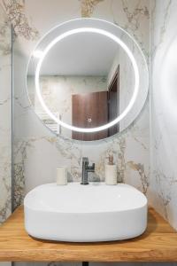 a bathroom with a white sink and a mirror at MUSES CHALKIDIKI #Skgbnb in Mesochórion +177 photos