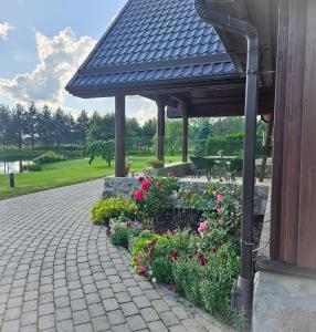 a gazebo with flowers in a garden at Jauki Lauki in Lejasciems