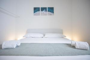 a white bed with white sheets and pillows at Casa Le Marinelle Amalfi Coast in Vietri sul Mare