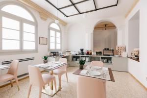 a room with two tables and chairs and a kitchen at Villa Turco Berti luxury apartments & SPA in Caldiero