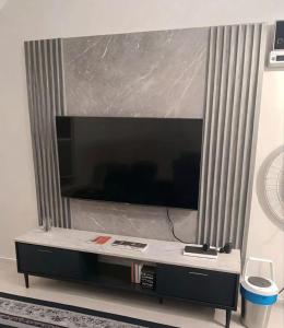 a large flat screen tv sitting on top of a table at Singgoh Tido Homestay in Bukit Payong +4 photos