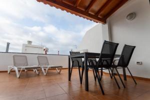 a black table and chairs on a balcony at Rayo de Sol Los Cristianos in Arona