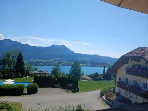 a house with a view of a lake and mountains at Dirnbergerhof in Mondsee