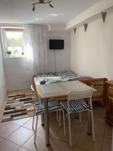 a small room with a table and a bed at Pokoje u Ani i Zbyszka in Wilkasy +2 photos