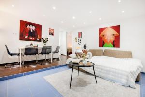 a bedroom with a bed and a living room with a table at Wellness Private Space in Gozdu with Jacuzzi in CBD in Budapest