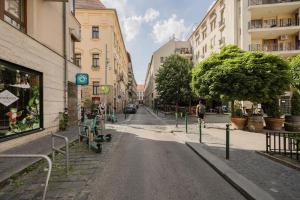an empty street in a city with buildings at Wellness Private Space in Gozdu with Jacuzzi in CBD in Budapest