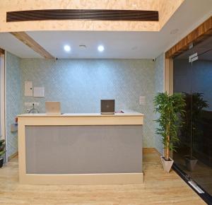 an office with a reception counter with two laptops on it at A K G Hotel in Puducherry +160 photos