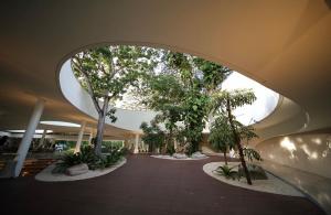 a hallway with trees and plants in a building at Tambuli Seaside Living Condominium -Private Host Tower D in Maribago