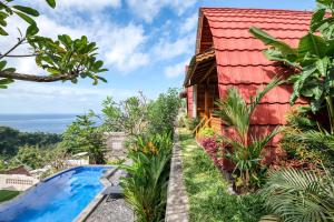 a house with a swimming pool and a red roof at Adinata Villa by Manara in Seraya