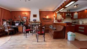 a kitchen and living room with a couch and chairs at Pokoje Wczasowe Barbara in Ustka