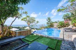 an image of a backyard with a swimming pool and benches at Adinata Villa by Manara in Seraya