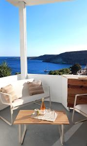 a patio with a couch and a table and a bottle of beer at Kanala Sea View in Kanala